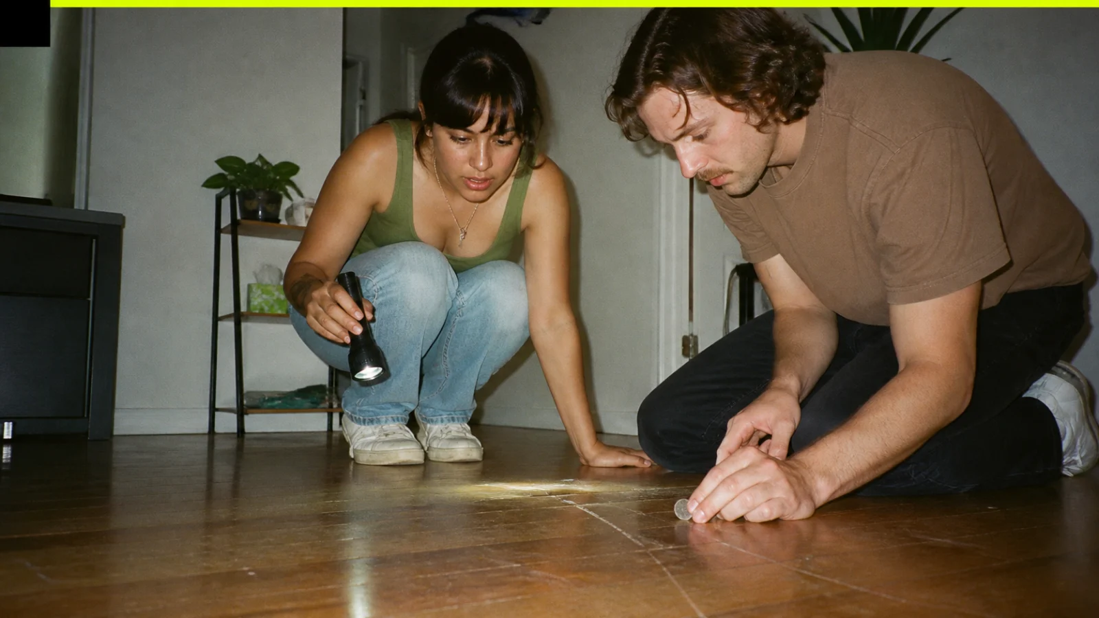 Renter comparing close-up hardwood scratch photos with move-in flooring records and refinishing quote