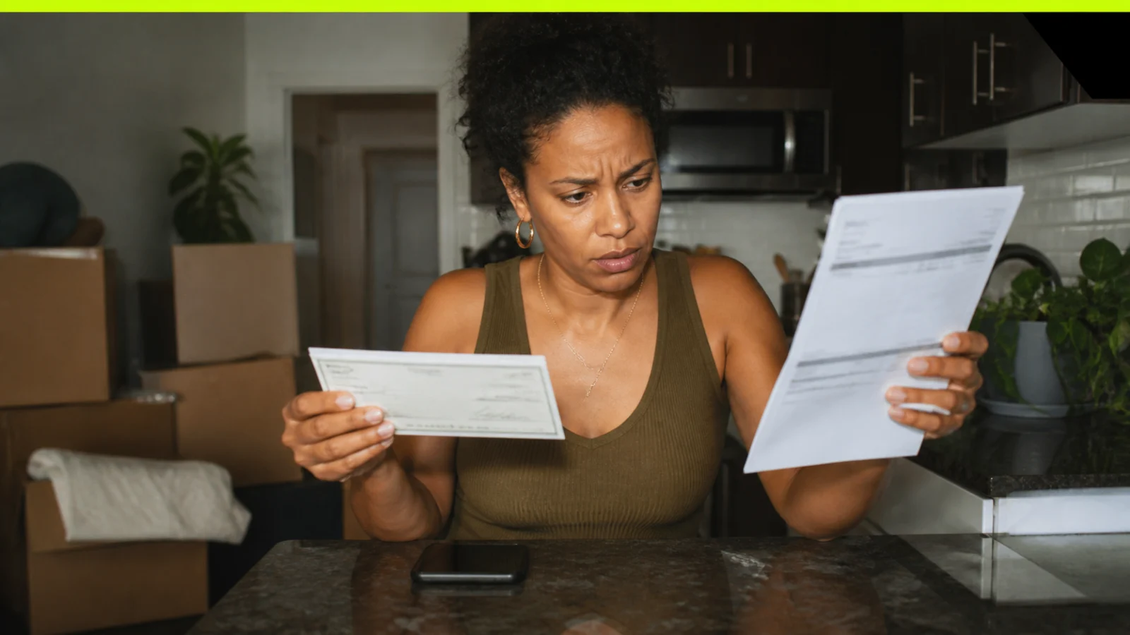 Renter comparing a refunded deposit check with a later itemized move-out bill and dated photographs